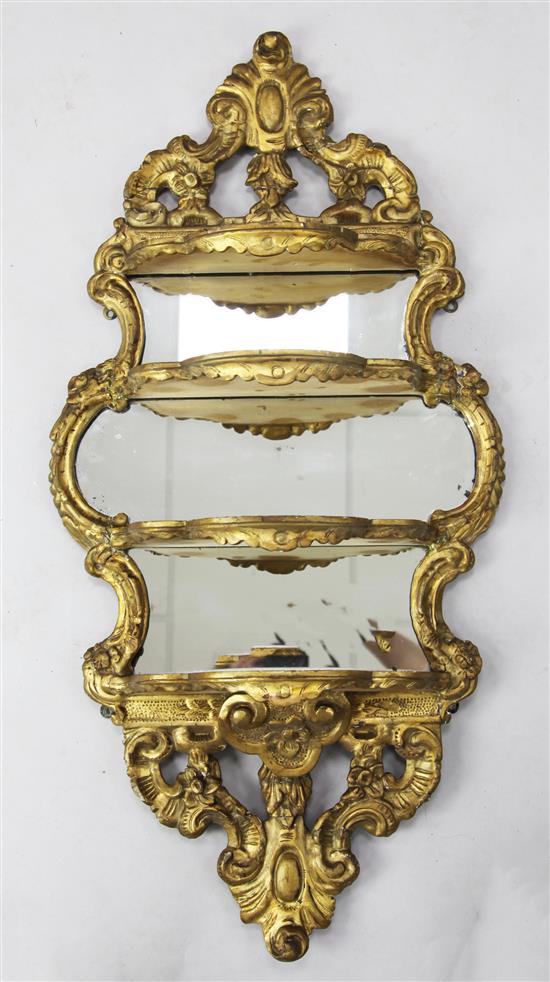 A Victorian giltwood and gesso four tier wall shelf, W.1ft 8in. H.3ft 2in.